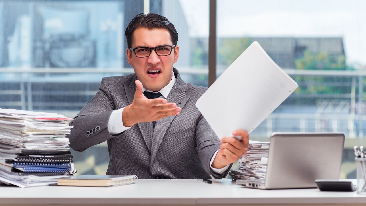 angry man holding a piece of paper